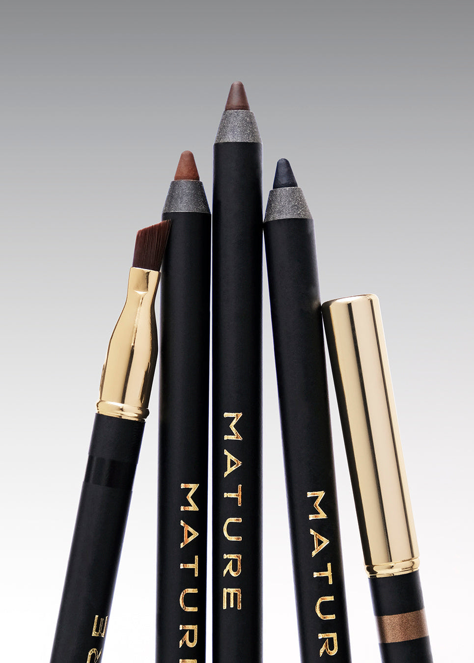 Three neutral necessities eyeliners close up showing the colors as well as showing the angled brush that appears on the other side of the brush.
