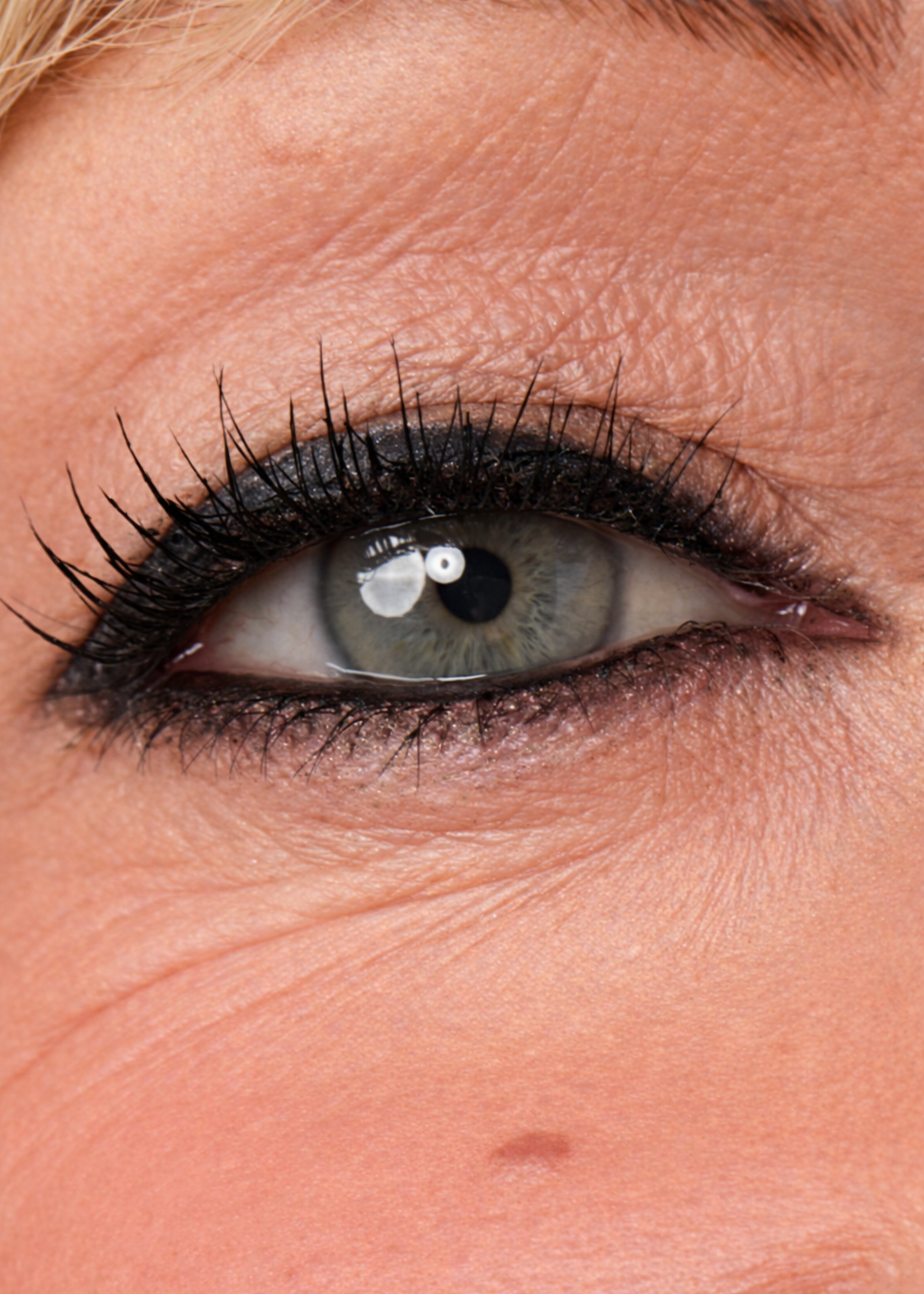 Close-up of a person's eye with black eyeliner and mascara.