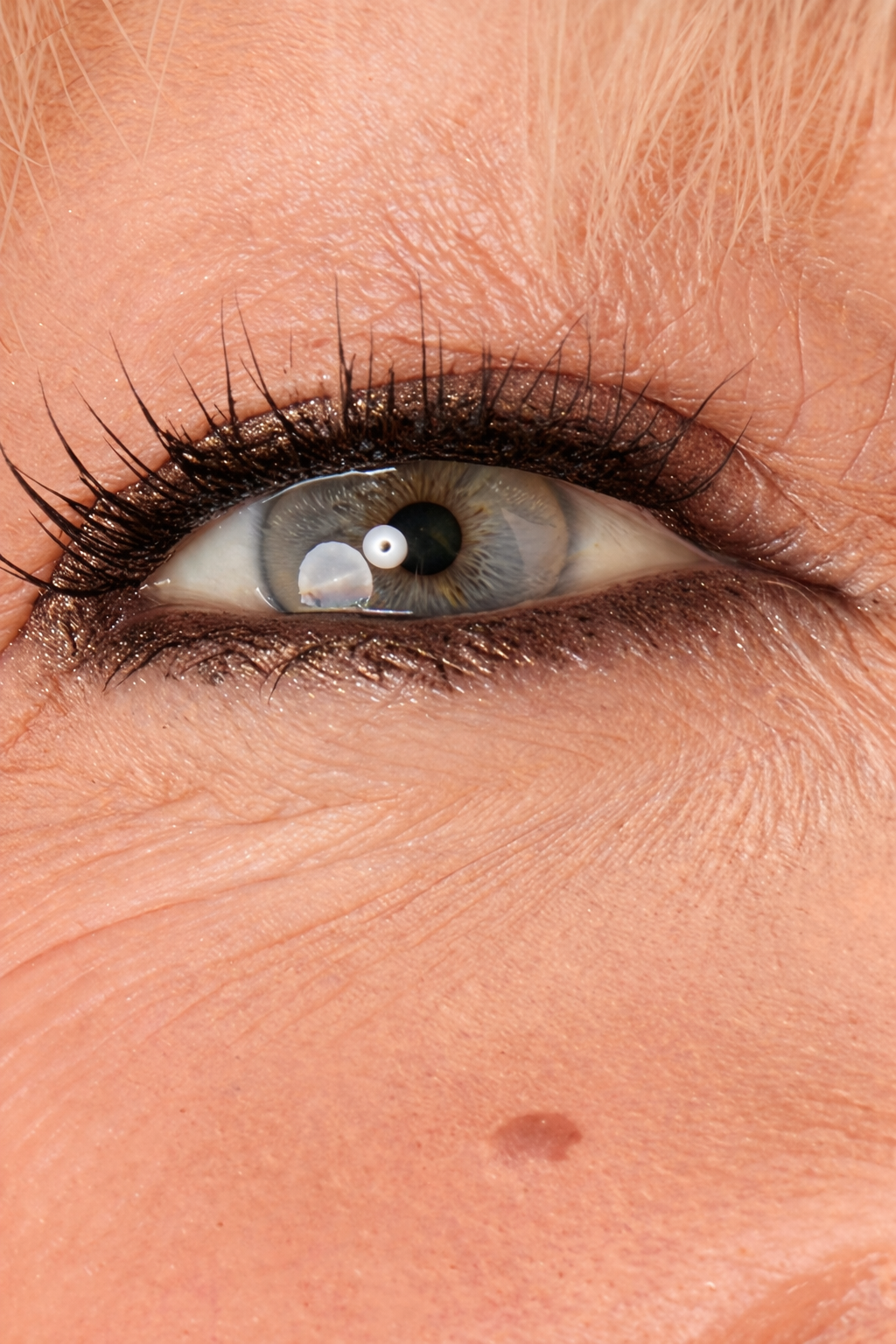 Close-up of a person's eye with Champagne Bronze eyeliner.
