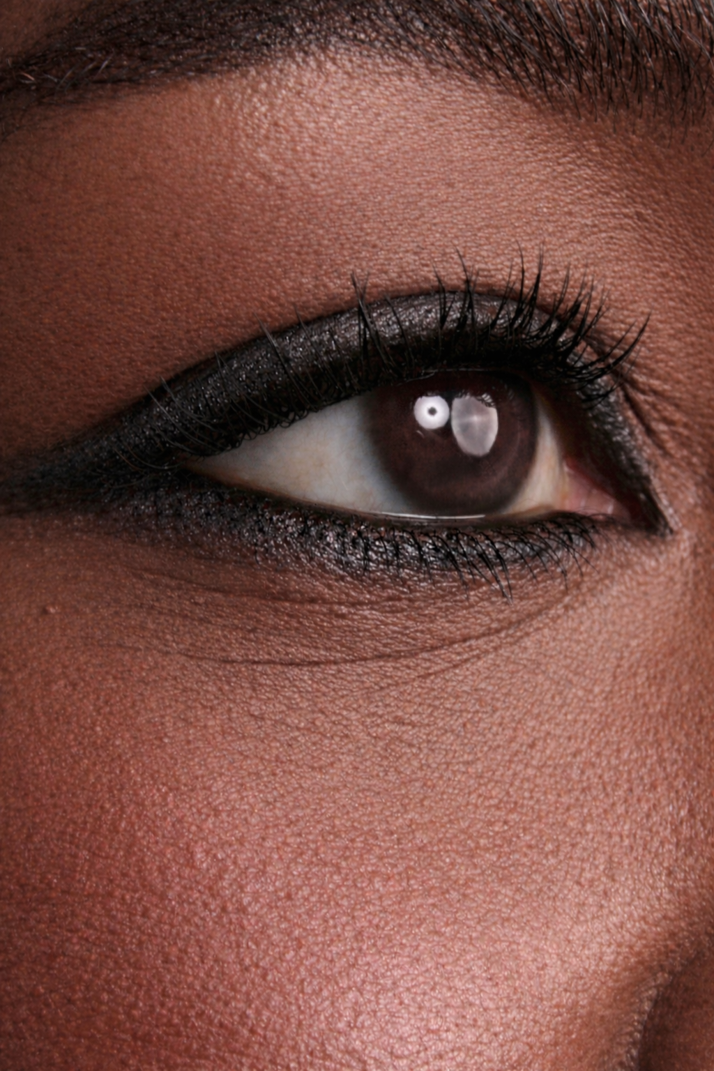 Close-up of a person's eye with steel gray eyeliner.