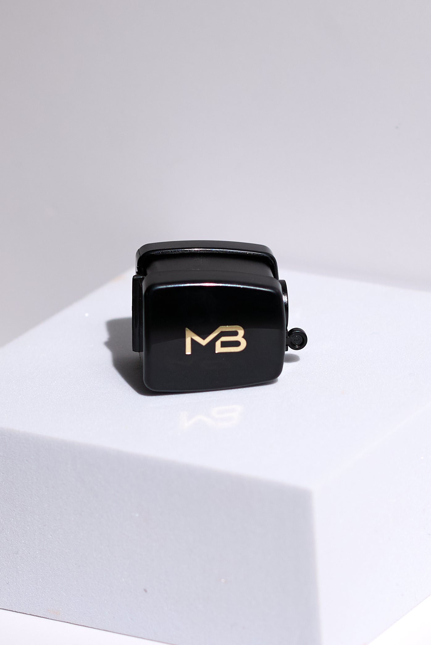 MB sharpener assembled and sitting on a white square.