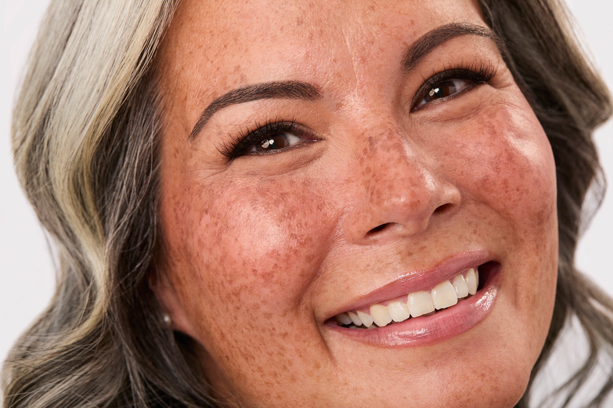 Close-up of a woman's face with a neutral background